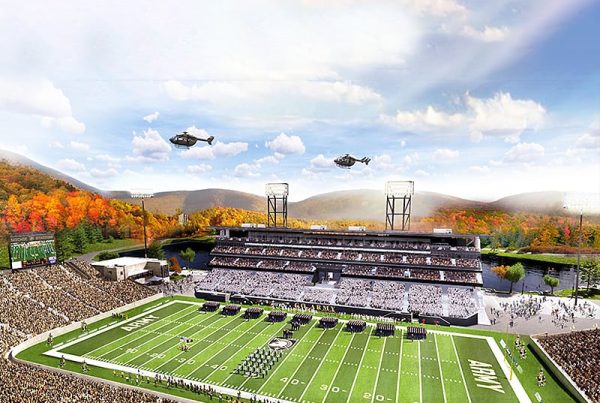 Aerial view of the historic Michie Stadium with crowds in the stands and helicopters in view.